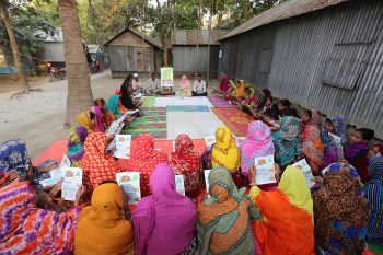 People attending a court yard meeting to learn more about Village Courts’ services